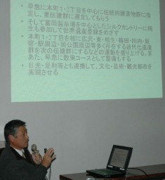 スクリーンを使って「のこぎり屋根の現況」を説明する佐々木さん